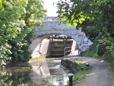 Typical original canal bridge at Norwood Locks White-painted arched bridge with lock behind